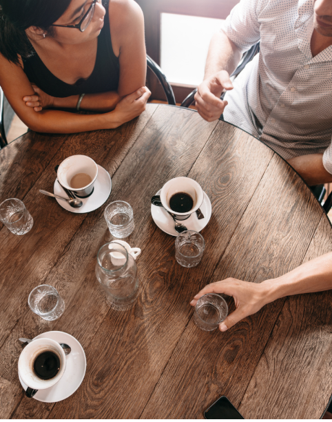 Coffee cups on a dark wooden table